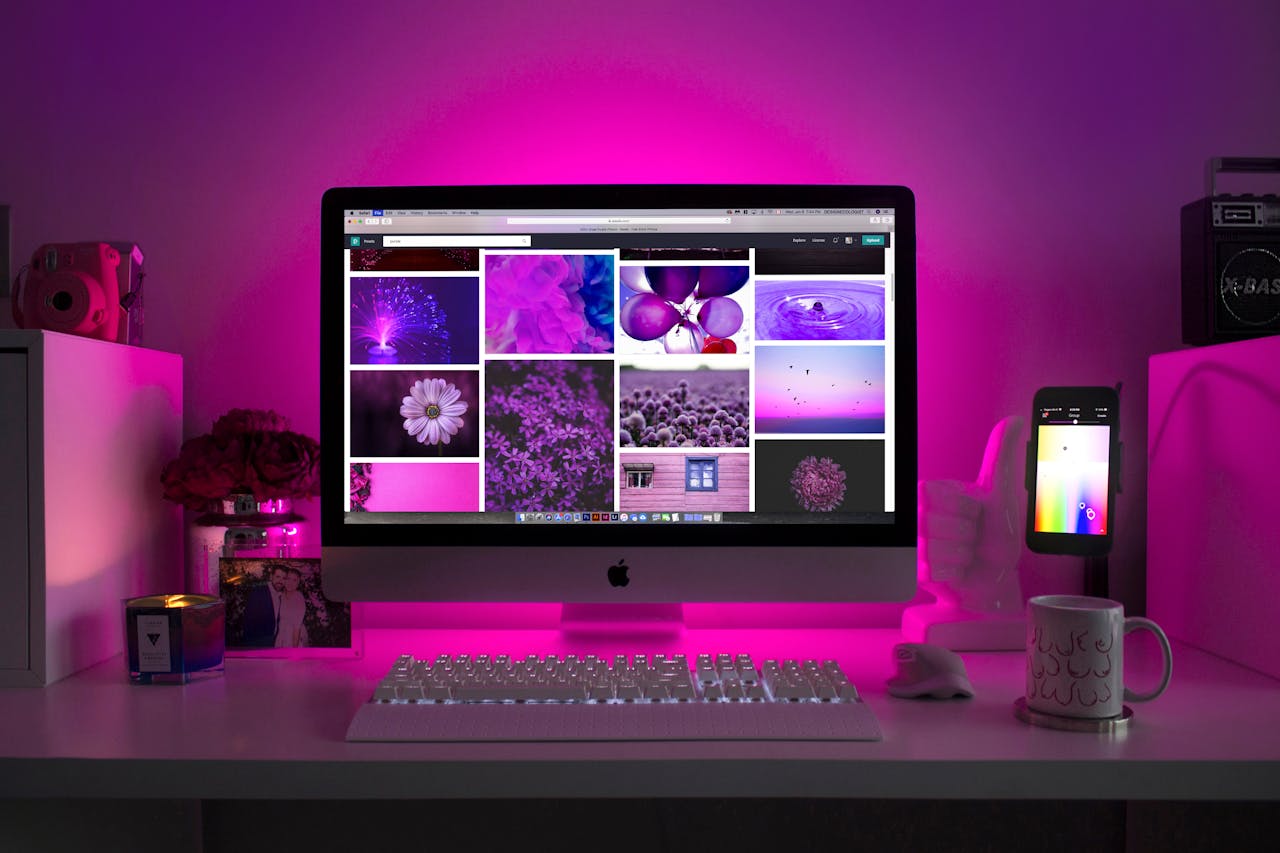 our-services-2 Modern desk setup with neon lighting and a desktop computer displaying colorful images.
